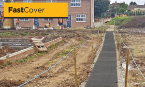 Temporary walkway across muddy field construction site